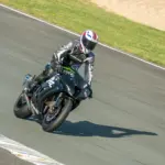 Helmeted rider wearing protective clothing on a sport motorcycle