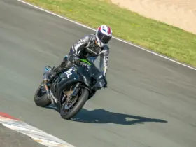 Helmeted rider wearing protective clothing on a sport motorcycle