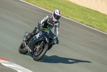 Helmeted rider wearing protective clothing on a sport motorcycle