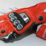 Red and white Dainese motorcycle racing gloves