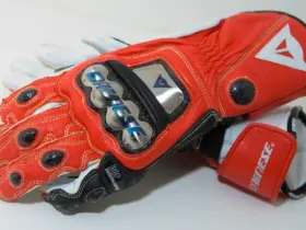 Red and white Dainese motorcycle racing gloves