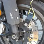 Disc lock secured through a motorcycle front brake disc