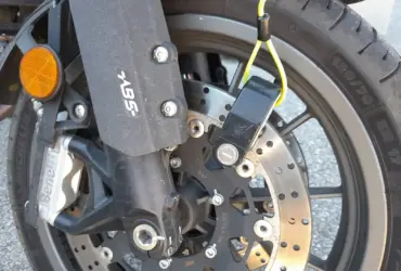 Disc lock secured through a motorcycle front brake disc
