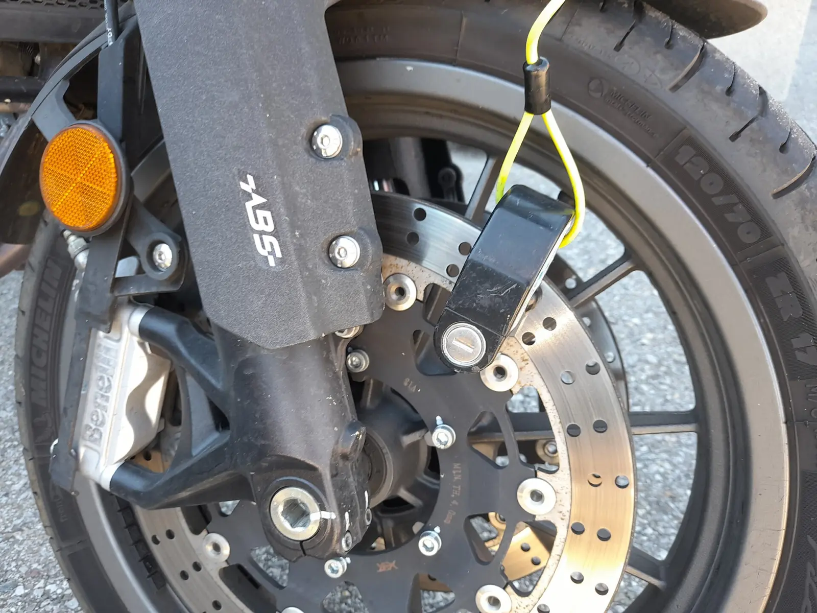 Disc lock secured through a motorcycle front brake disc