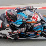 Motorcycle racer wearing protective leathers on a racing circuit