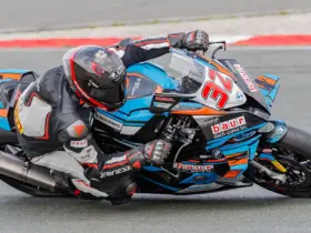 Motorcycle racer wearing protective leathers on a racing circuit
