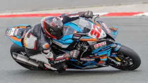 Motorcycle racer wearing protective leathers on a racing circuit