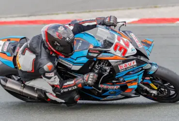 Motorcycle racer wearing protective leathers on a racing circuit