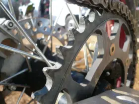 Close-up of a motorcycle chain and rear sprocket