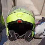 High-visibility motorcycle helmet beside riding clothing