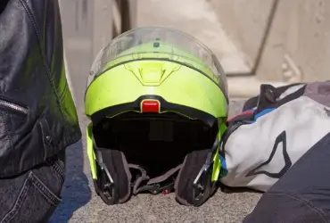 High-visibility motorcycle helmet beside riding clothing