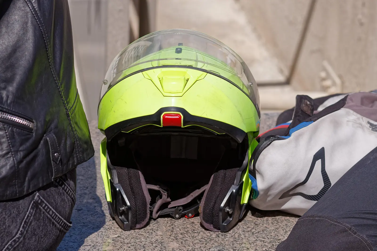 High-visibility motorcycle helmet beside riding clothing