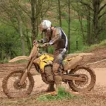 Motocross rider wearing boots, gloves and protective riding clothing