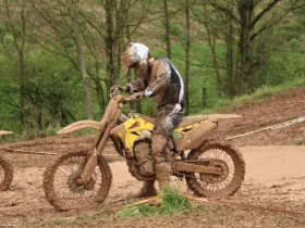 Motocross rider wearing boots, gloves and protective riding clothing