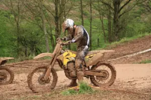 Motocross rider wearing boots, gloves and protective riding clothing