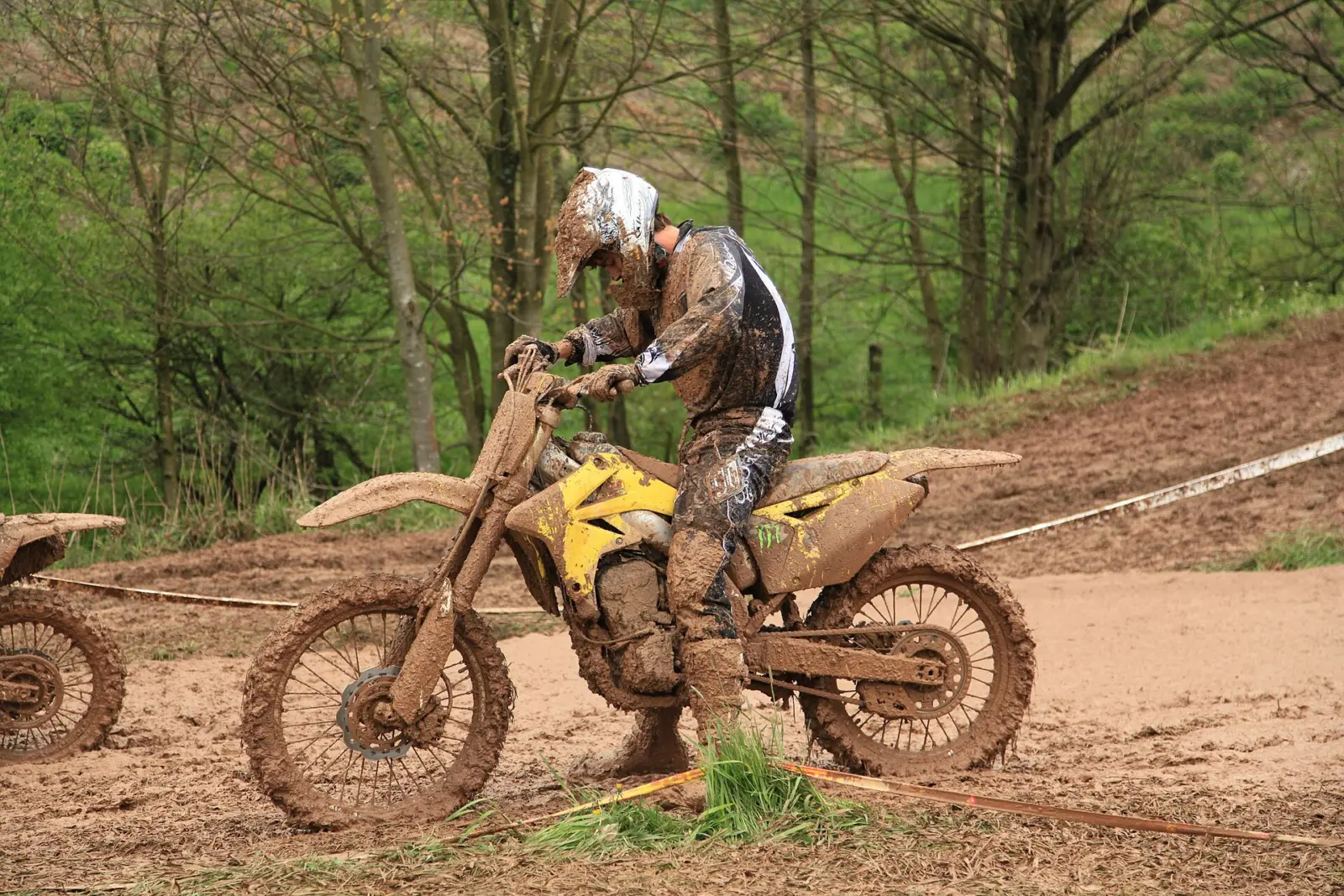 Motocross rider wearing boots, gloves and protective riding clothing