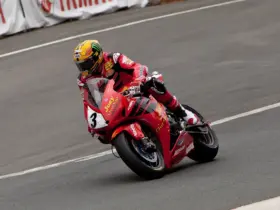 Motorcycle racer in red protective leathers on a racing circuit