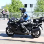 Motorcyclist wearing a blue and grey textile riding jacket
