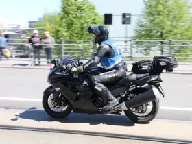 Motorcyclist wearing a blue and grey textile riding jacket
