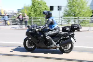 Motorcyclist wearing a blue and grey textile riding jacket