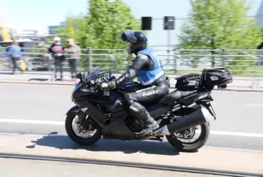 Motorcyclist wearing a blue and grey textile riding jacket