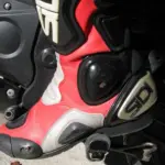 Close-up of a red and black motorcycle racing boot