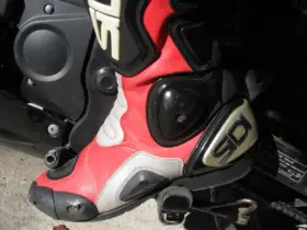 Close-up of a red and black motorcycle racing boot