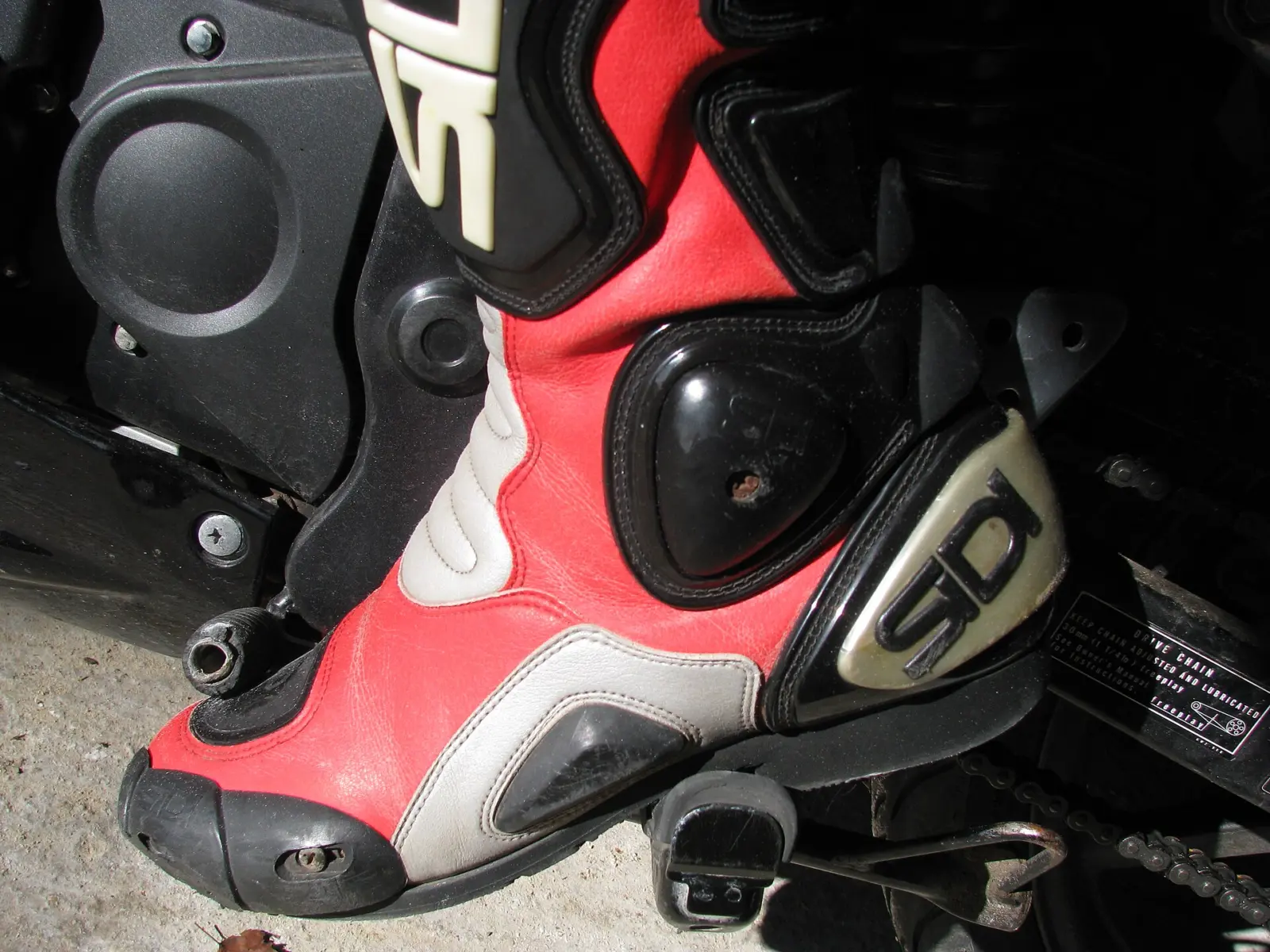 Close-up of a red and black motorcycle racing boot