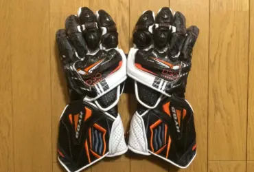 Pair of black, white and orange motorcycle racing gloves