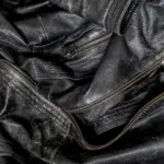 Close-up of the zips and texture of a black leather jacket