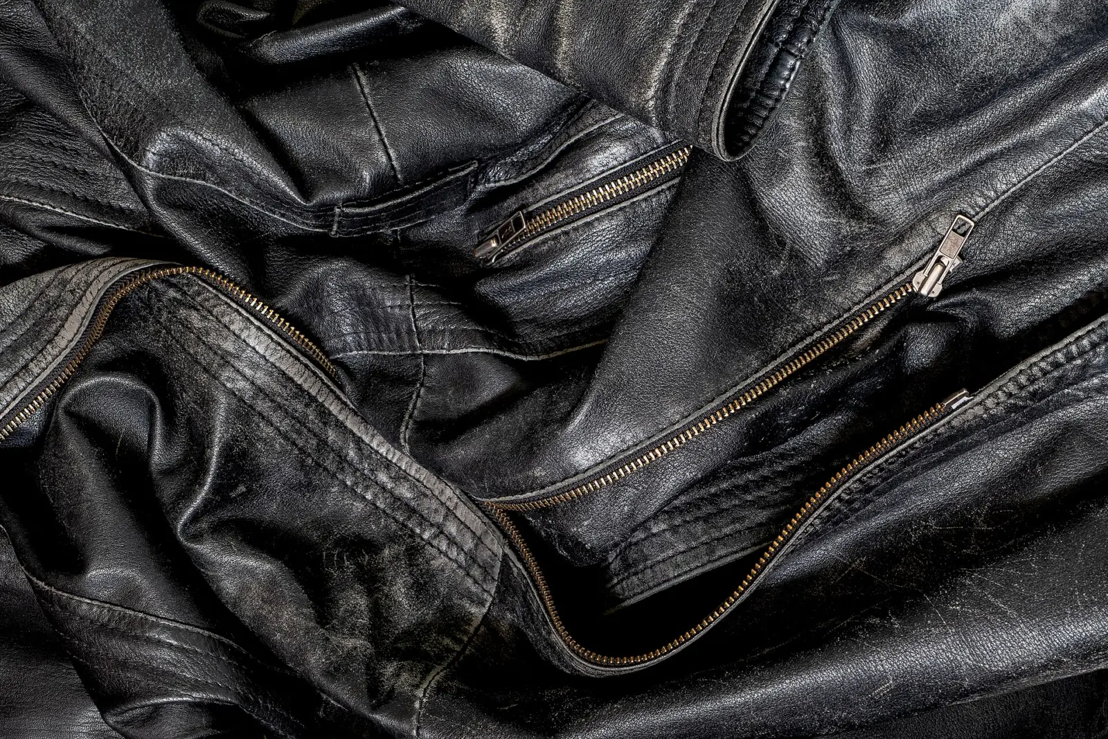 Close-up of the zips and texture of a black leather jacket