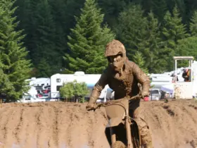 Motocross rider wearing a helmet, goggles and protective riding clothing