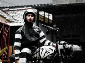 Motorcyclist wearing rain gear in rainfall