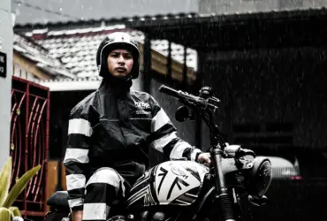 Motorcyclist wearing rain gear in rainfall