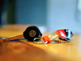 Motorcycle key with a metal keyring and fabric lanyard