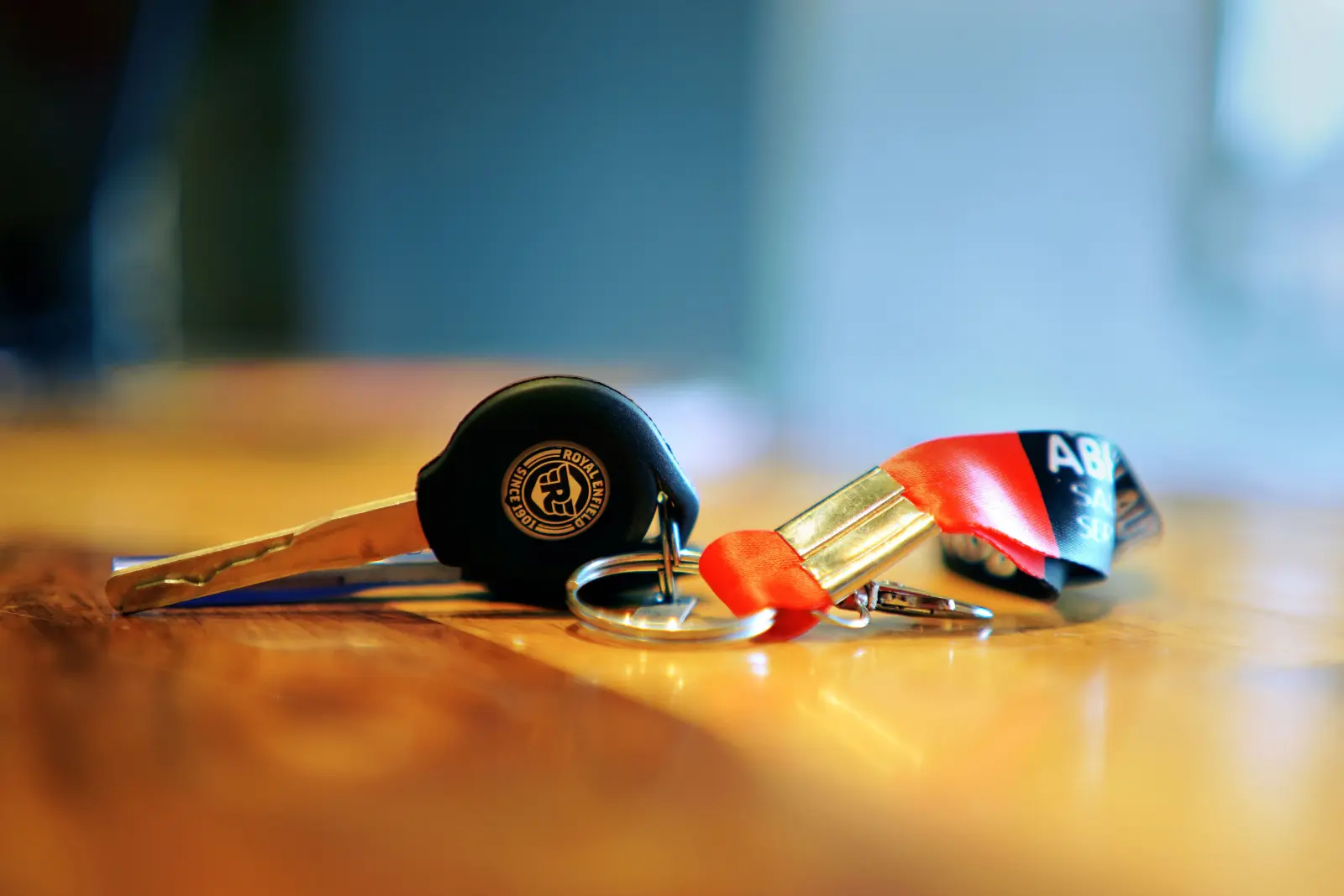 Motorcycle key with a metal keyring and fabric lanyard